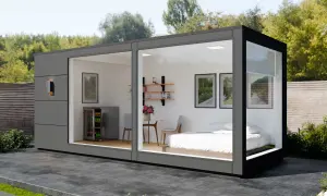 Modernes Container Haus mit Bett, Kühlschrank und Sitzbereich. Informieren Sie sich über die Container haus kosten für Ihr Traumhaus.