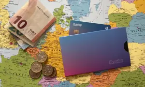Euro banknoty, monety i karty Revolut leżą na mapie Europy. Czy Revolut jest darmowy? Sprawdź, zanim wyruszysz w podróż!