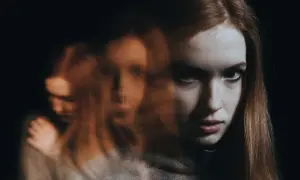 Rozmyte twarze kobiety, symbolizujące zmienne nastroje i walkę z chorobą dwubiegunową.