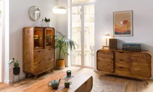 Ciepły, **kolor miodowy w salonie** tworzą meble z litego drewna, retro gramofon i stylowe dodatki.