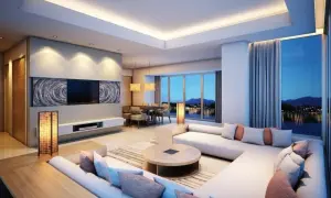 Illuminazione a led integrata in un controsoffitto in cartongesso, che valorizza un salotto moderno con vista lago.