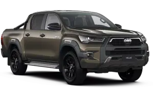 Brązowy Toyota Hilux z czarnymi felgami i relingami. Sprawdź aktualną toyota hilux cena i zamów swój wymarzony samochód.