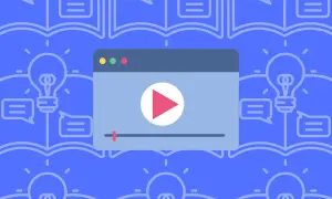 Otwarta książka z żarówką i dymkami dialogowymi. Obok odtwarzacz wideo. To idealny motyw, o czym można napisać opowiadanie.