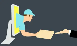 Kurier wychodzi z monitora, wręczając paczkę. To symbol szybkiego **drop shipingu** i dostawy online.