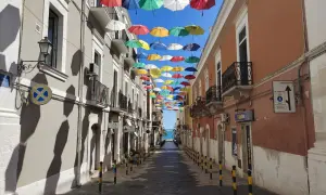 Un vicolo colorato da ombrelli sospesi, un'installazione artistica che rende unica Manfredonia. Ecco cosa vedere a Manfredonia per un'esperienza indimenticabile.