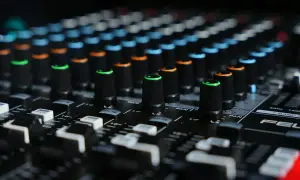Close-up of a mixing board with colorful knobs, ready to shape sounds like a bitcrusher in FL Studio.