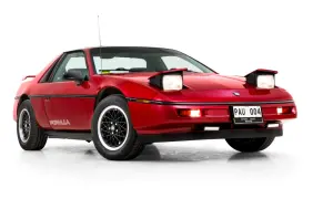 Röd Pontiac Fiero Formula från 80-talet med uppfällda strålkastare.