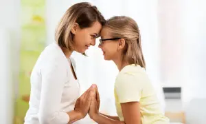 Madre e figlia si guardano con affetto, le fronti unite. Un momento di connessione profonda, che a volte può nascondere la psicologia di una madre invidiosa della figlia.