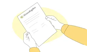 Händer håller ett papper med texten "Kronofogden" och en logotyp. Kanske ett brev om inkasso.