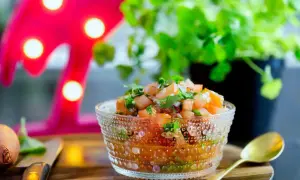 En skål med färsk salsa, perfekt för ditt nästa salsa recept. Tomater, lök och koriander i en vacker glasburk.