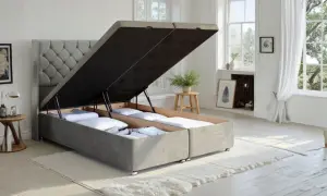 A divan bed with its storage compartments open, revealing neatly folded linens. This versatile divan offers ample hidden storage.
