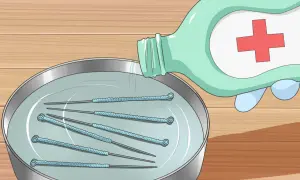 Pour du liquide désinfectant sur des aiguilles dans un bol pour comment stériliser une aiguille.