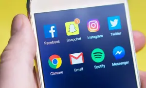 Ekran smartfona z ikonami aplikacji: Facebook, Snapchat, Instagram, Twitter, Chrome, Gmail, Spotify, Messenger. Dowiedz się, jak wyłączyć dostępność na Messengerze.