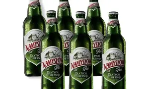 Sechs Flaschen Namysłów Pils, das beste polnische Bier, stehen nebeneinander.