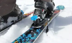 Narty z butami w śniegu. Czy snowboard jest bezpieczniejszy od nart? To pytanie zadaje sobie wielu narciarzy.