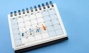 Figurki ludzi na kalendarzu z napisem "4-day work week". Pomaga to zrozumieć, jak wyliczyć średnioroczne zatrudnienie.