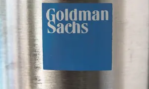 Niebieski kwadrat z logo Goldman Sachs, symbolizujący stabilny wzrost i pewność w świecie finansów.