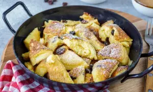 Ein köstlicher Kaiserschmarrn, frisch aus der Pfanne, mit Rosinen und Puderzucker bestäubt. Ein einfaches Rezept für Genuss.