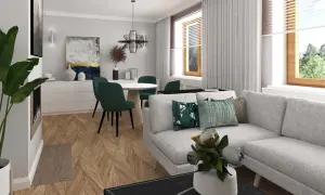 Jasnoszara kanapa z zielonymi poduszkami, okrągły stół z krzesłami w tym samym kolorze, drewniana podłoga w jodełkę i ściany w kolorze popielatym tworzą przytulne wnętrze.