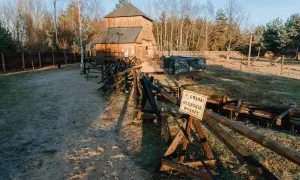 Drewniana wieża i okopy w Tomaszowie Mazowieckim. Ostrzeżenie "Uwaga! Gębokie wykopy" przypomina o historii tego miejsca.