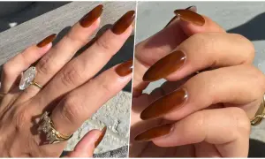 Manucure marron élégante sur des ongles longs et pointus, ornés de bagues scintillantes.
