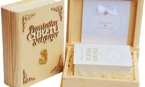 Drewniana księga z napisem "Pamiątka Chrztu Świętego" i złotym aniołkiem. W otwartym pudełku pamiątkowym znajduje się Pismo Święte.
