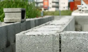 Budowa domu w toku. Widoczne zbrojenie pustaków szalunkowych, gotowych do zalania betonem.