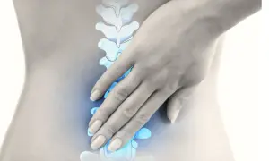 Eine Hand berührt die Wirbelsäule, die aus vielen Wirbeln besteht. Die Frage, wie viele Wirbel hat ein Mensch, wird hier visuell angedeutet.