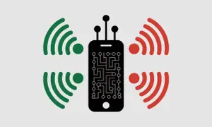 Smartphone noir avec circuit imprimé, entouré de signaux verts et rouges. L'iPhone 11 est-il 5G ou pas ?