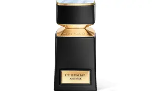Elegancka butelka perfum Bvlgari Le Gemme Amunae w kolorze czarnym ze złotymi detalami i kamieniem na wieczku.