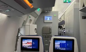 Blick in ein Flugzeug, wo man bequem sitzen kann. Die Bildschirme zeigen die Sitzplätze 28B und 28C.