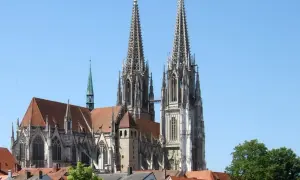 Der Regensburger Dom mit seinen markanten Türmen ragt majestätisch in den blauen Himmel.