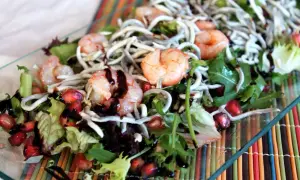 Deliciosa ensalada de gulas con gambas, granada y aderezo balsámico.