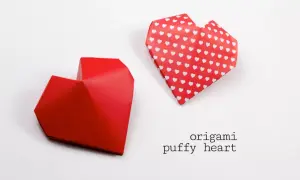 Dwa czerwone serca z origami, jedno gładkie, drugie w białe serduszka. Dowiedz się, jak narysować serce w tej technice.