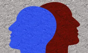 Dwie sylwetki głów, niebieska i czerwona, na tle chropowatej ściany. Symbolizują złożoność ludzkiej psychiki i potencjalne zaburzenia osobowości przyczyny.
