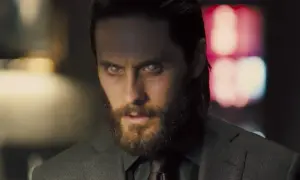 Jared Leto w filmach, z bladymi oczami i brodą, w garniturze.