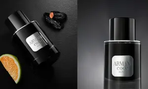 Eleganckie perfumy męskie Armani Code Elixir w czarnej butelce, obok pomarańczy i daktyli.