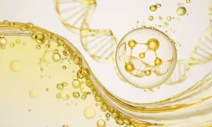 Złote kropelki i struktura DNA, w centrum molekuła peptyd miedziowy w bańce.