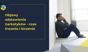 Mężczyzna siedzi przy ścianie, z rękami na twarzy, przeżywając trudne chwile związane z syndromem odstawienia narkotyków.