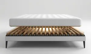 A mattress rests on a slatted bed frame, showcasing the best wood for bed slats for optimal support and breathability.