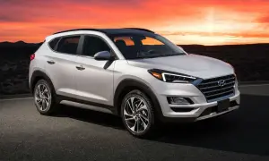 Un Hyundai Tucson blanco con un motor potente, listo para la aventura al atardecer en un paisaje desértico.