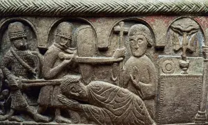 Stenrelief med en scen som påminner om martyriet av **Saint Sebastian**. Soldater förbereder sig, en man ligger ner, och en annan håller ett kors.