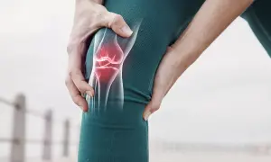 Schmerzendes Knie mit leuchtend rotem Meniskus, der auf eine mögliche Meniskus-OP hinweist.
