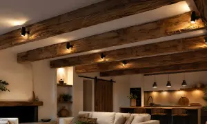 Poutre apparente en bois vieilli, éclairée par des spots discrets. Ambiance rustique et chaleureuse.