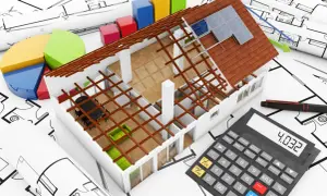 Ocieplenie domu koszt. Model domu, wykresy, kalkulator i plany architektoniczne symbolizują planowanie i koszty inwestycji.