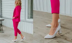 Elegancka kobieta w fuksjowym garniturze i białych czółenkach na słupku. Idealne buty do damskiego garnituru, które dodają klasy.