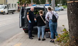 Strażnik miejski rozmawia z kobietami obok radiowozu. Może to być interwencja dotycząca zakłócania ciszy nocnej, wezwanie policji było konieczne.