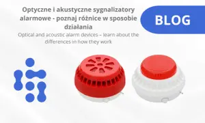 Dwa sygnalizatory akustyczno optyczne, jeden czerwony, drugi biało-czerwony, obok niebieskiego logo.