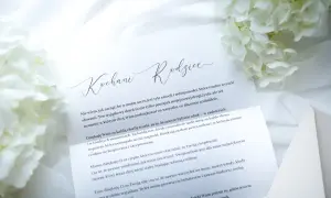 Drodzy rodzice, list z podziękowaniami i wyrazami miłości. Białe kwiaty i elegancka koperta podkreślają uroczysty charakter.