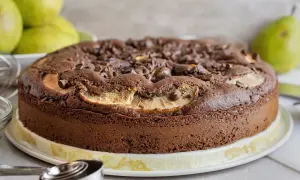 Torta pere e cioccolato, soffice e golosa, con tante gocce di cioccolato e fette di pera che spuntano dalla superficie.